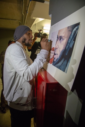 The moment that Yasiin Bey found a spot to tag the original watercolor. Photo by Greg Boulden